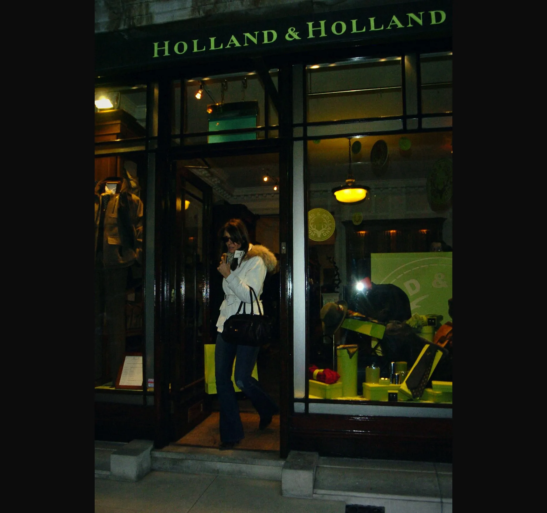 BRUTON STREET. A wider frame outside the Holland & Holland shopfront on Bruton Street, off New Bond Street, with Hurley in the doorway.