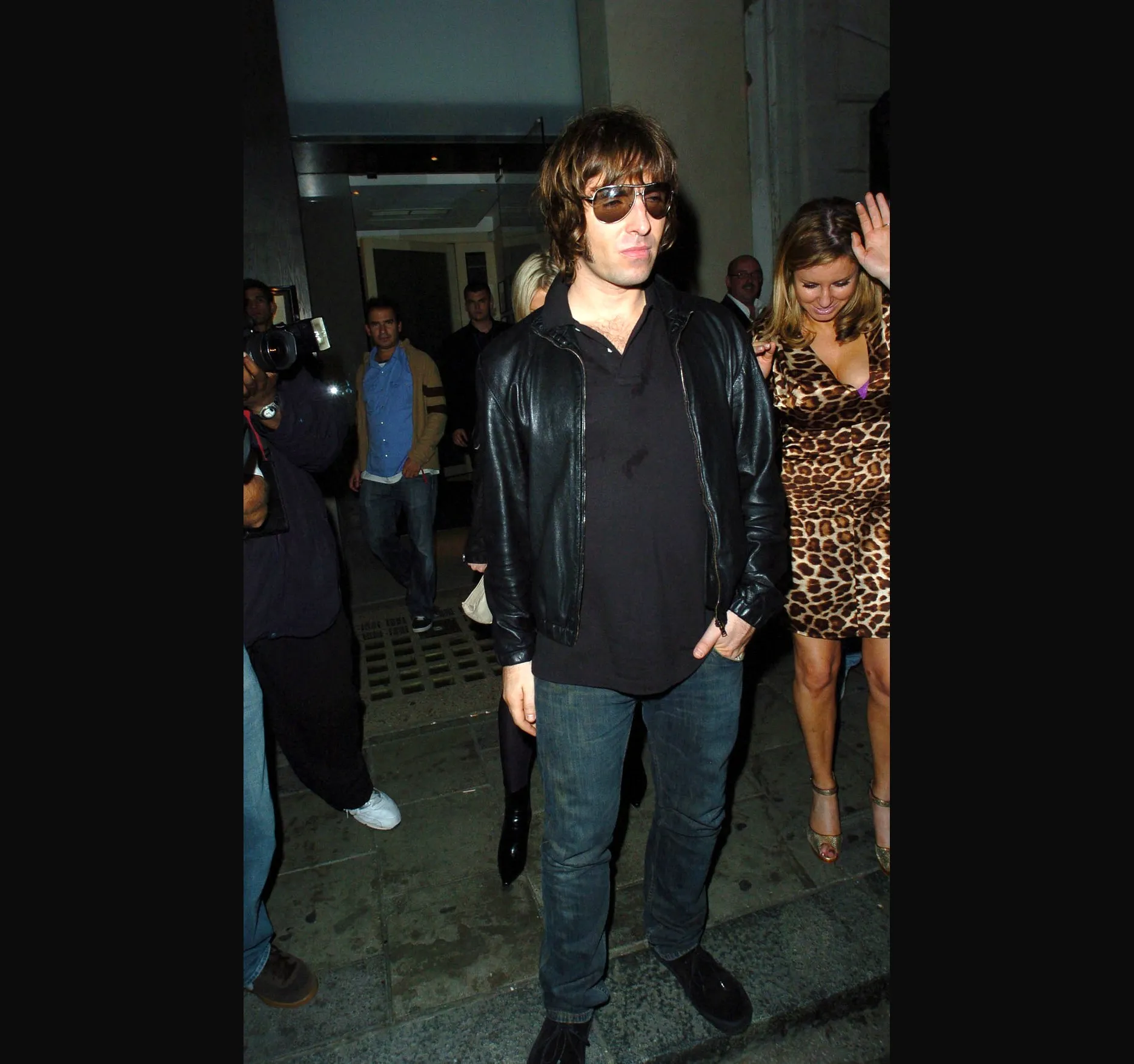NOBU, SEPTEMBER 2006. Liam Gallagher leaves Nobu restaurant in London on the night of 21 September 2006, his 34th birthday, into the early hours of 22 September. His then girlfriend, Nicole Appleton, is with him. They married in 2008. Here is Liam, shades on, hands in pockets, walking out into a crowd of cameras.